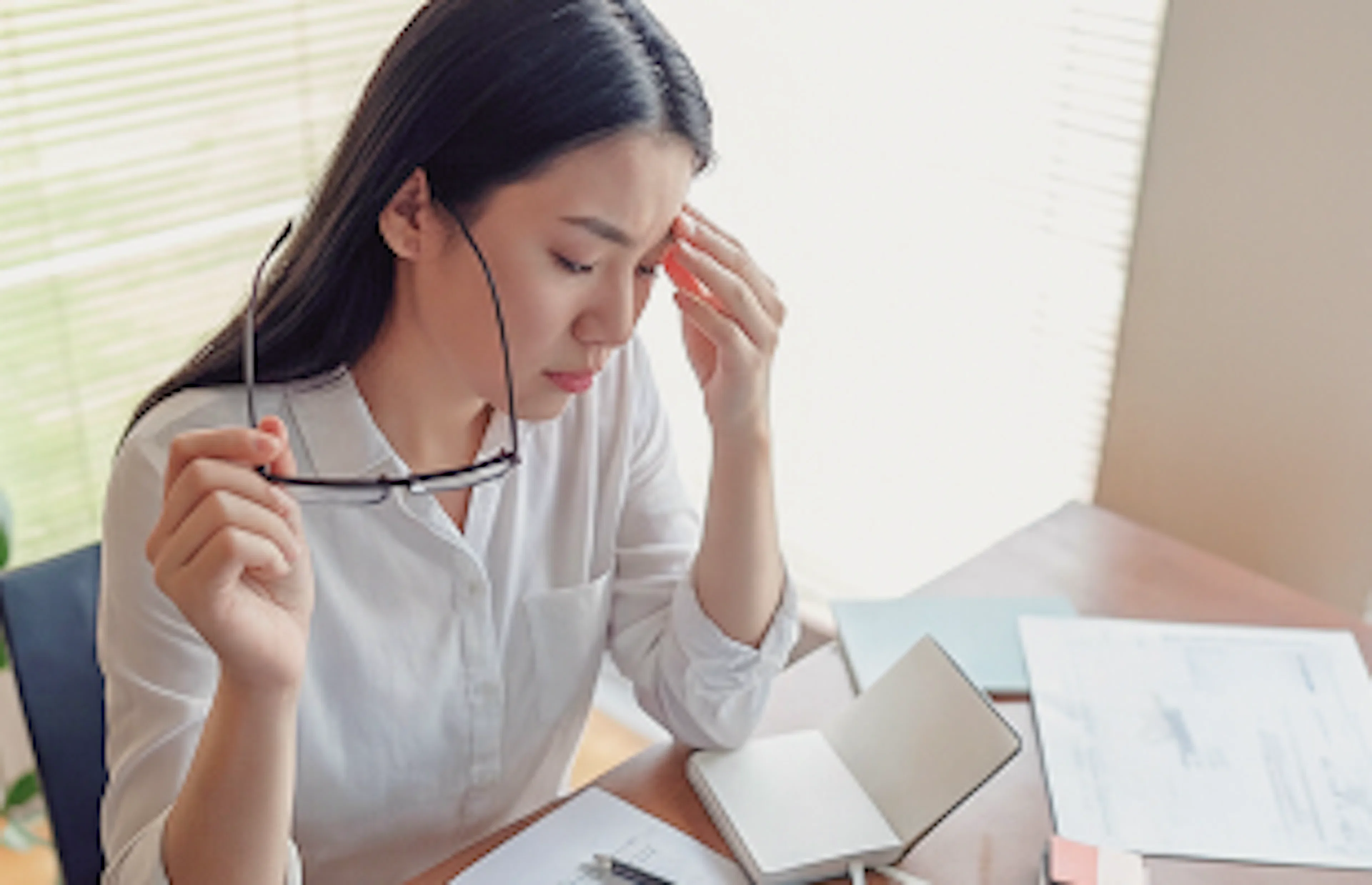 Therapist looking stressed at desk